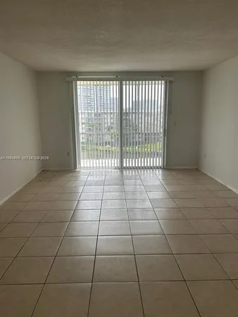 a view of a livingroom with a floor to ceiling window and carpet