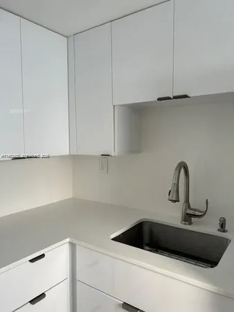 a kitchen with a sink and cabinets