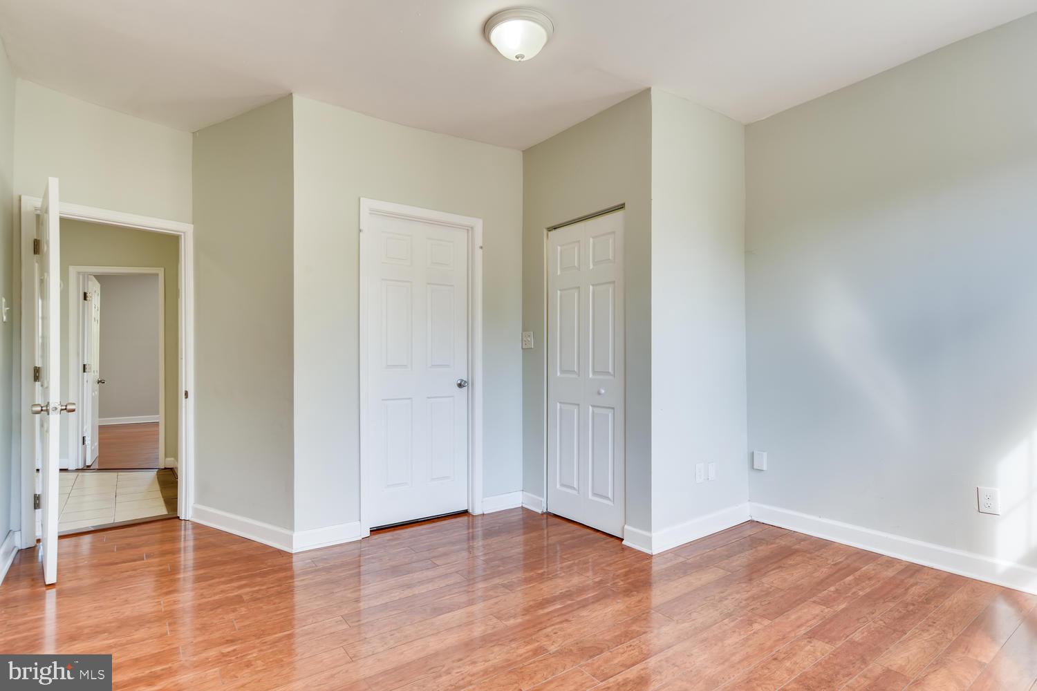 3610 Greenmount Avenue Baltimore, MD 21218 - Photo 12 of 24 an empty room with wooden floor and a window