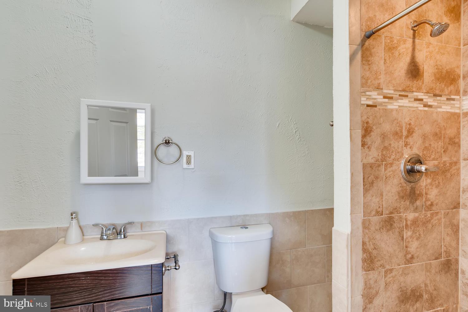 3610 Greenmount Avenue Baltimore, MD 21218 - Photo 13 of 24 a bathroom with a sink a toilet and shower