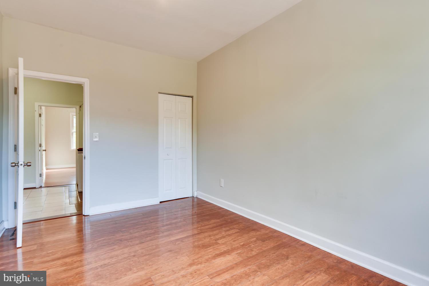 3610 Greenmount Avenue Baltimore, MD 21218 - Photo 15 of 24 a view of an empty room with wooden floor