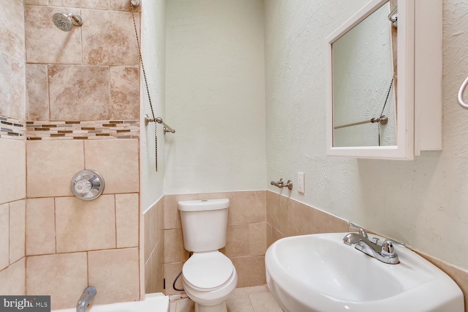 3610 Greenmount Avenue Baltimore, MD 21218 - Photo 18 of 24 a bathroom with a toilet sink and mirror
