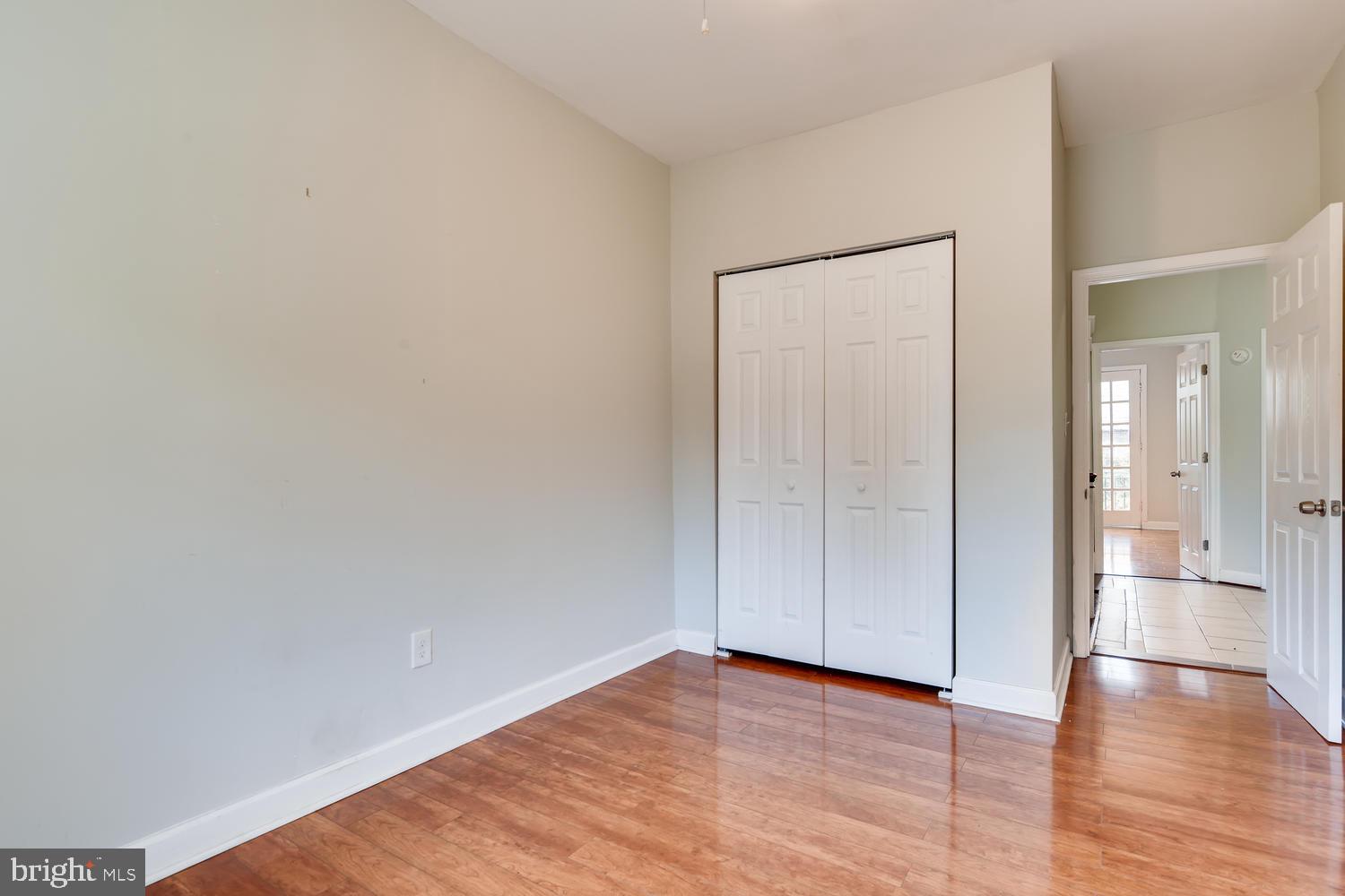 3610 Greenmount Avenue Baltimore, MD 21218 - Photo 20 of 24 a view of an empty room with wooden floor and a window