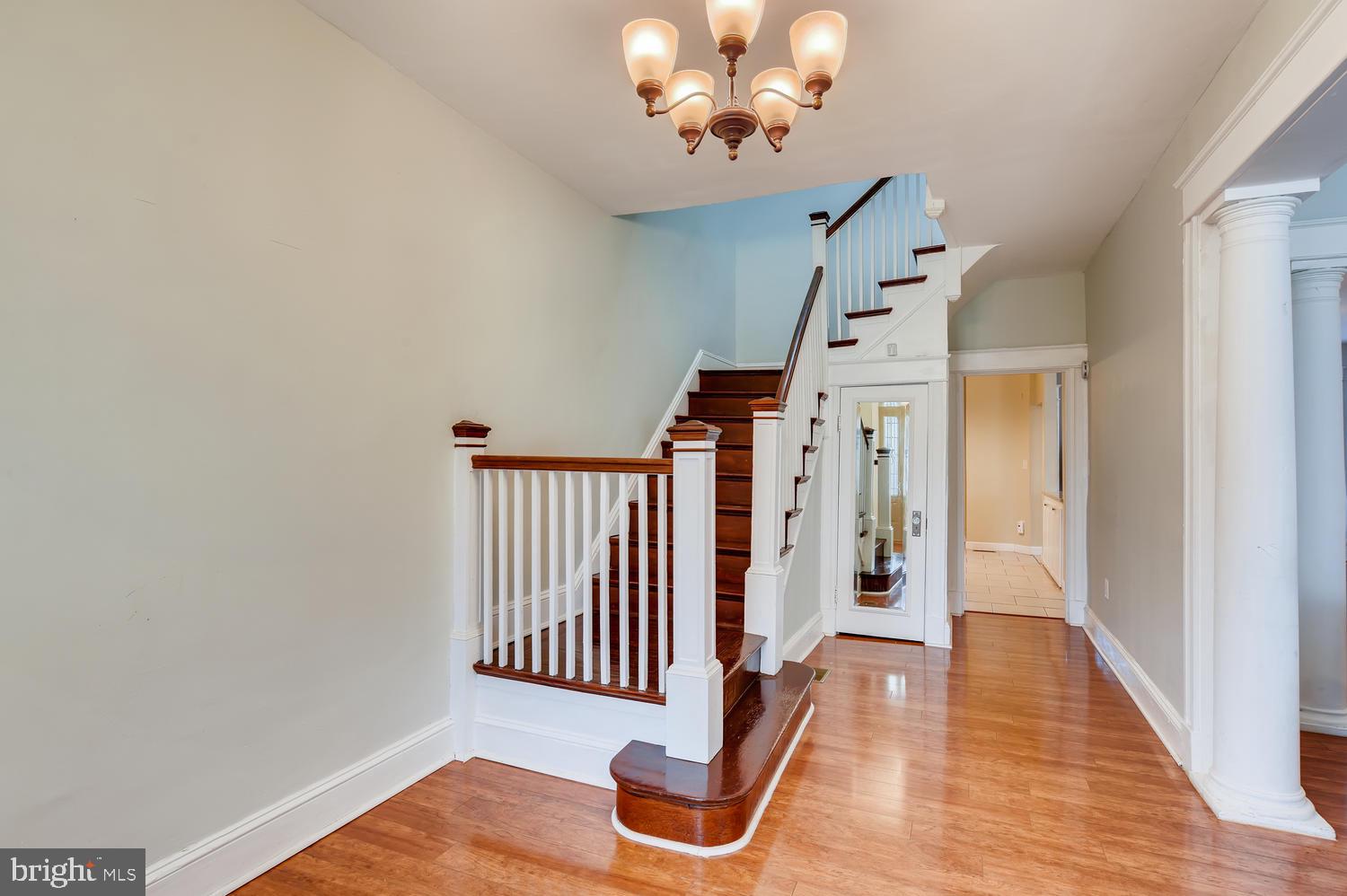 3610 Greenmount Avenue Baltimore, MD 21218 - Photo 2 of 24 a view of a hallway with wooden floor and staircase