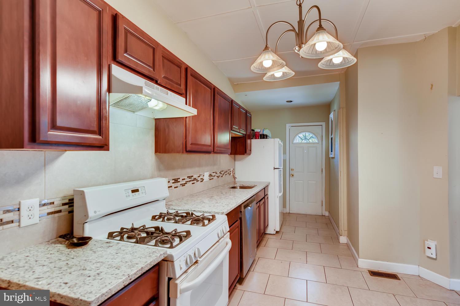 3610 Greenmount Avenue Baltimore, MD 21218 - Photo 7 of 24 a kitchen with stainless steel appliances granite countertop a sink stove and refrigerator