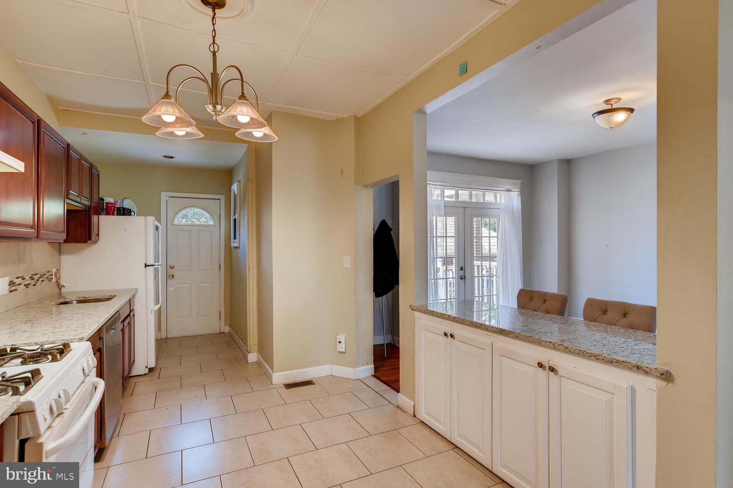 3610 Greenmount Avenue Baltimore, MD 21218 - Photo 8 of 24 a view of a kitchen with granite countertop cabinets a sink and stainless steel appliances