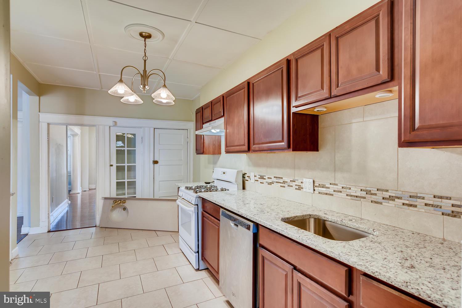 3610 Greenmount Avenue Baltimore, MD 21218 - Photo 9 of 24 a kitchen with a sink a counter space cabinets and appliances