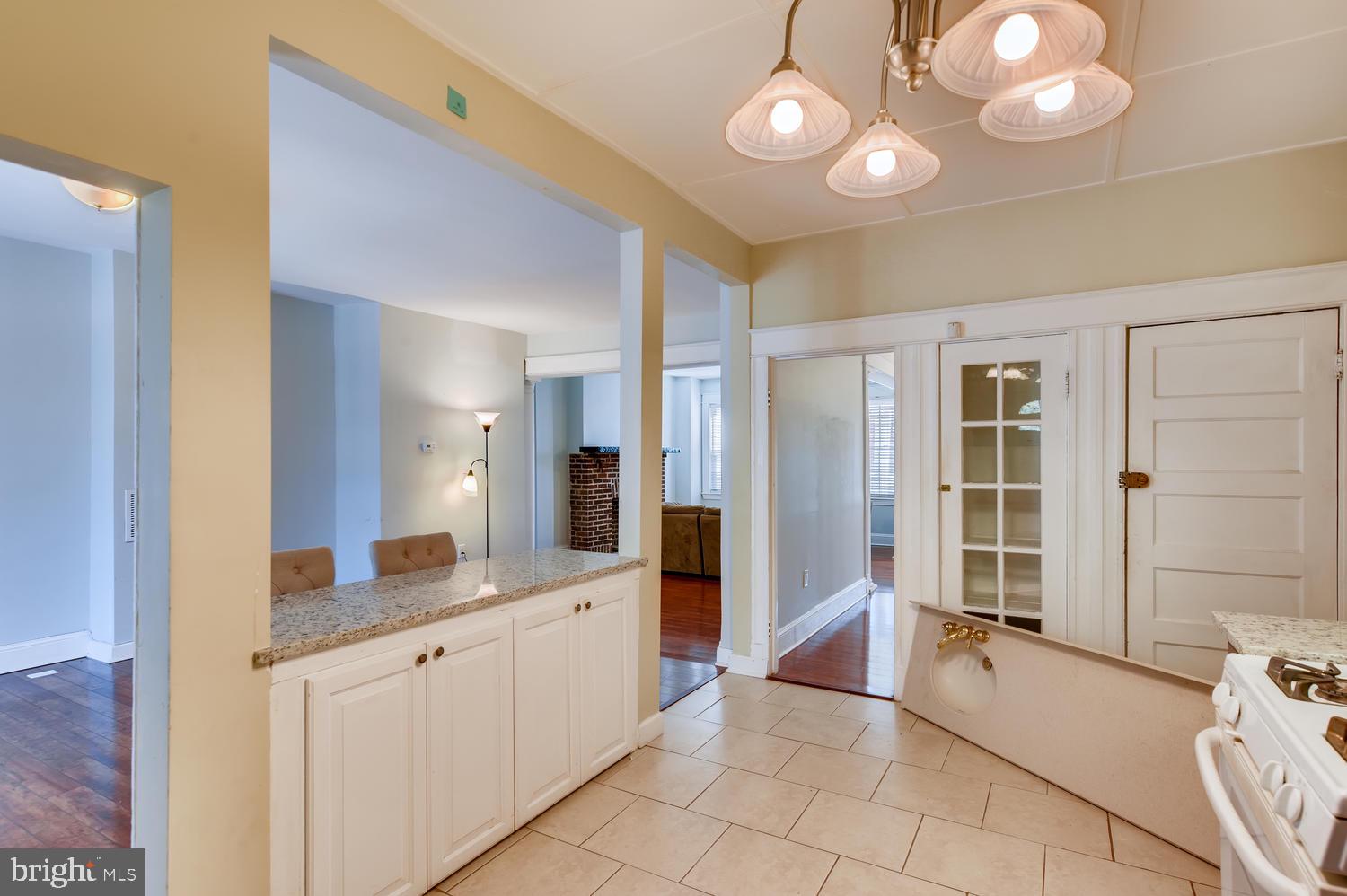 3610 Greenmount Avenue Baltimore, MD 21218 - Photo 10 of 24 a large bathroom with a large mirror vanity and shower