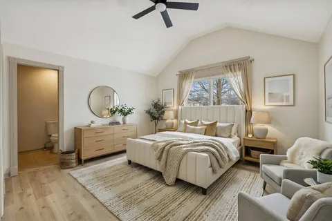 a bed room with a bed mirror and window