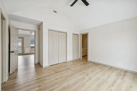 a view of a room with wooden floor and a bathroom