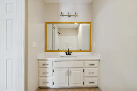 a bathroom with a sink and a mirror
