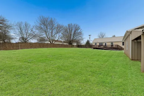 a view of a yard with a house in the background
