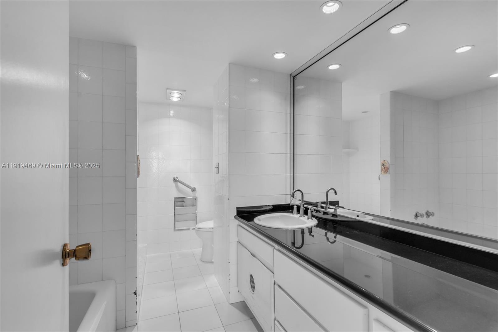 200 Ocean Ln Drive, Unit 407GR09 Key Biscayne, FL 33149 - Photo 15 of 56 a bathroom with a sink and a mirror