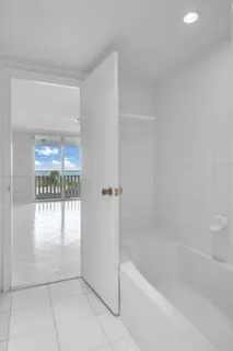 a view of a small space with wooden floor and a window