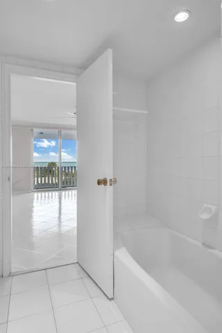 a view of a small space with wooden floor and a window