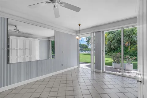 a view of an empty room with a window and cabinet