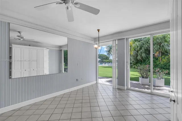 a view of an empty room with a window and cabinet