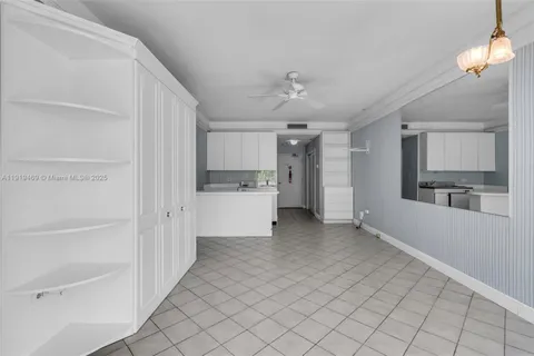 a view of a kitchen with a refrigerator and a sink