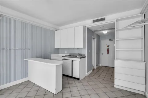 a kitchen with a sink cabinets and stainless steel appliances