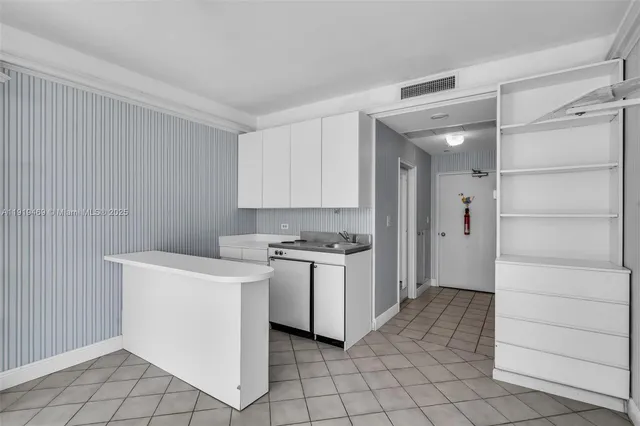 a kitchen with a sink cabinets and stainless steel appliances