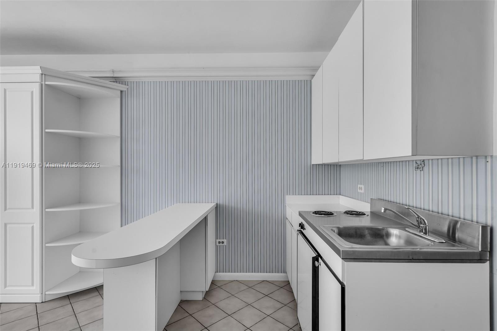 200 Ocean Ln Drive, Unit 407GR09 Key Biscayne, FL 33149 - Photo 32 of 56 a kitchen with a sink cabinets and stainless steel appliances