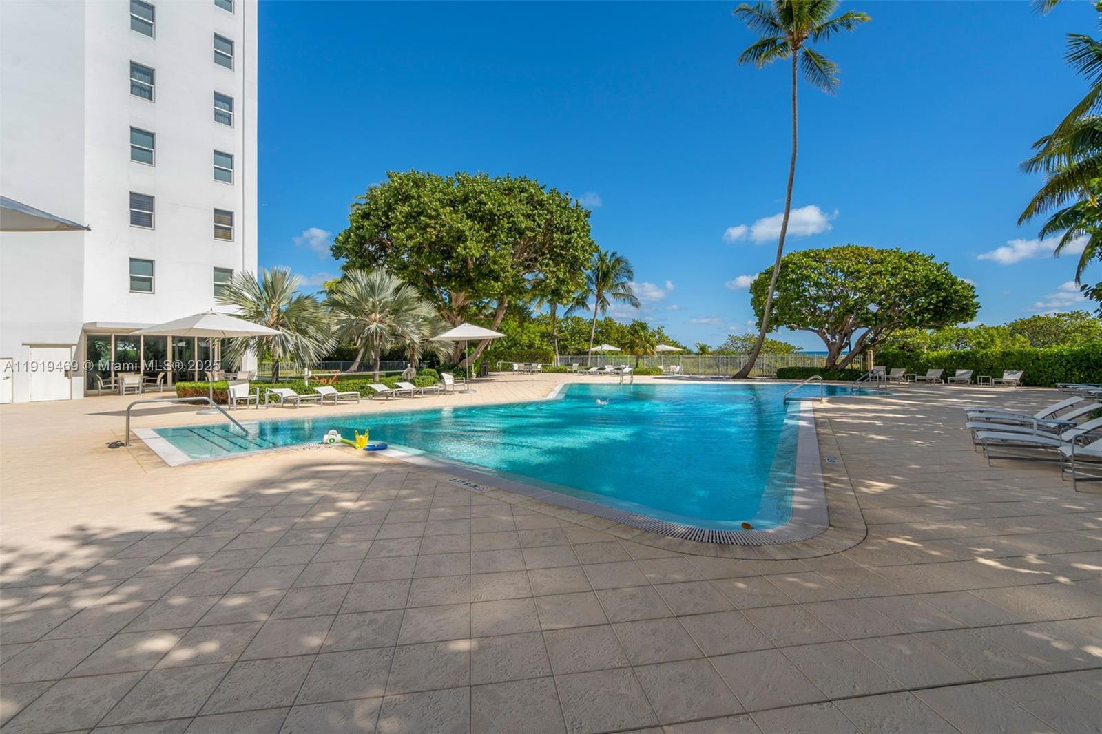 200 Ocean Ln Drive, Unit 407GR09 Key Biscayne, FL 33149 - Photo 34 of 56 a view of a yard with a table and chairs