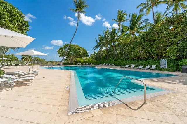 a view of backyard with swimming pool and patio