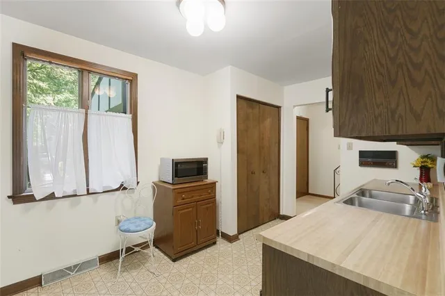 a kitchen with granite countertop a sink stove and refrigerator