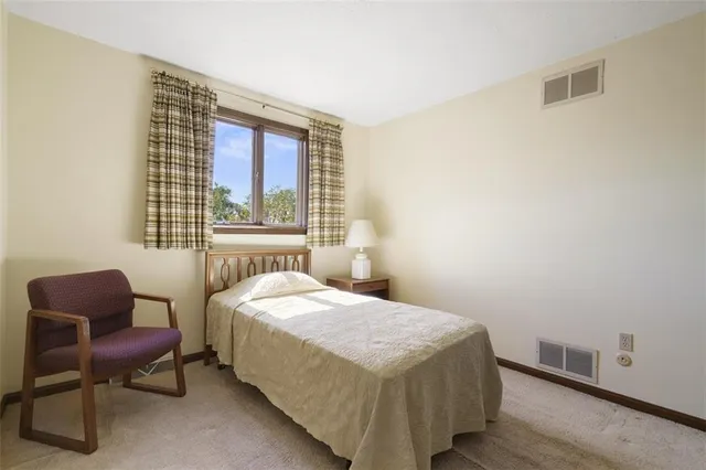 a bedroom with a bed and a chair