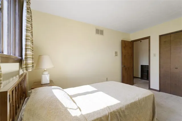 a bedroom with a bed and a lamp