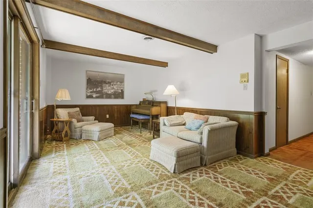 a living room with furniture and painting on the wall