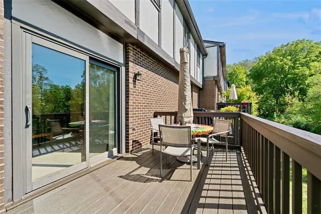 a view of balcony with chairs and wooden fence