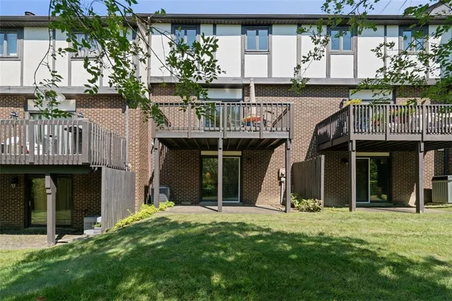 a view of small house with front door and wooden floor