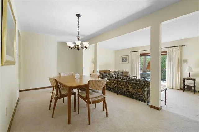 a view of a dining room with furniture and chandelier