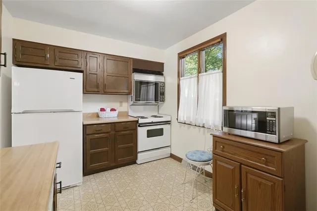 a kitchen with a refrigerator stove and microwave