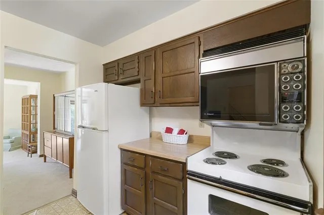 a kitchen with stainless steel appliances a refrigerator stove and microwave