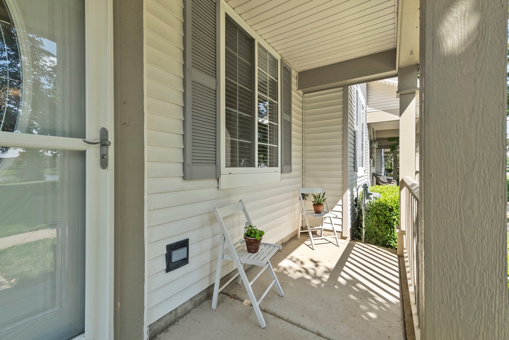 1565 Azalea Circle Romeoville, IL 60446 - Photo 22 of 30 a view of a porch with chairs and potted plants
