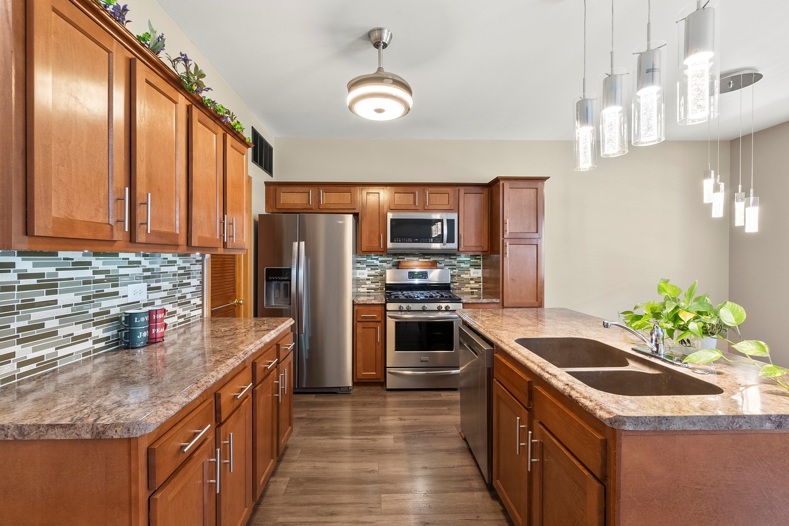 1565 Azalea Circle Romeoville, IL 60446 - Photo 4 of 30 a kitchen with kitchen island granite countertop stainless steel appliances a sink stove and refrigerator