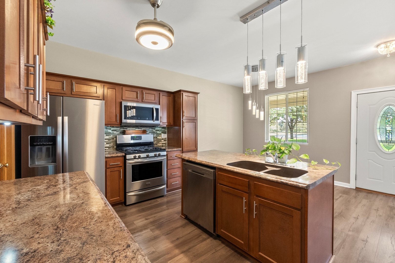1565 Azalea Circle Romeoville, IL 60446 - Photo 5 of 30 a kitchen with stainless steel appliances granite countertop a stove refrigerator and microwave