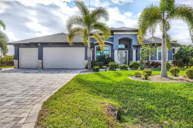 a front view of a house with garden and plants