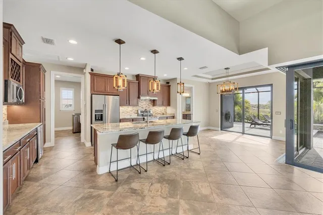 a large kitchen with a table and chairs