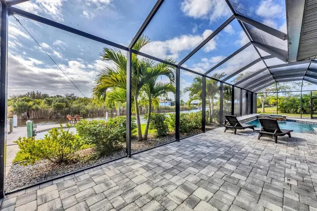a view of a porch with chairs and backyard