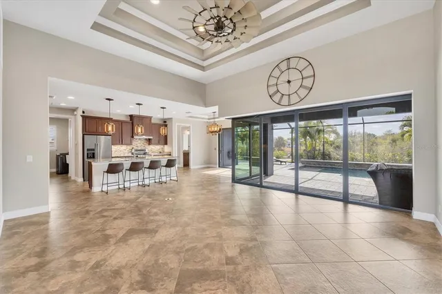 a view of a hallway with furniture and a large window