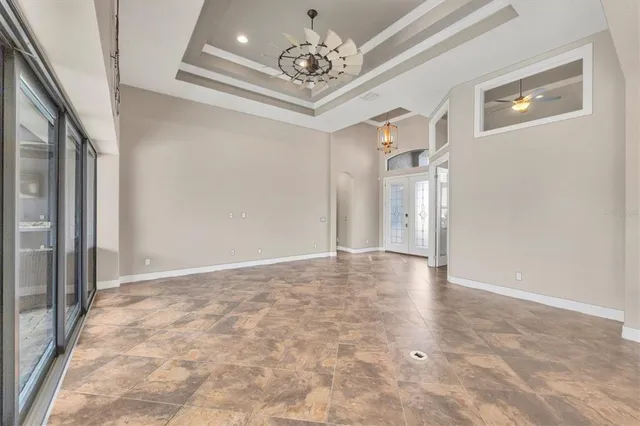 a view of an empty room with a chandelier