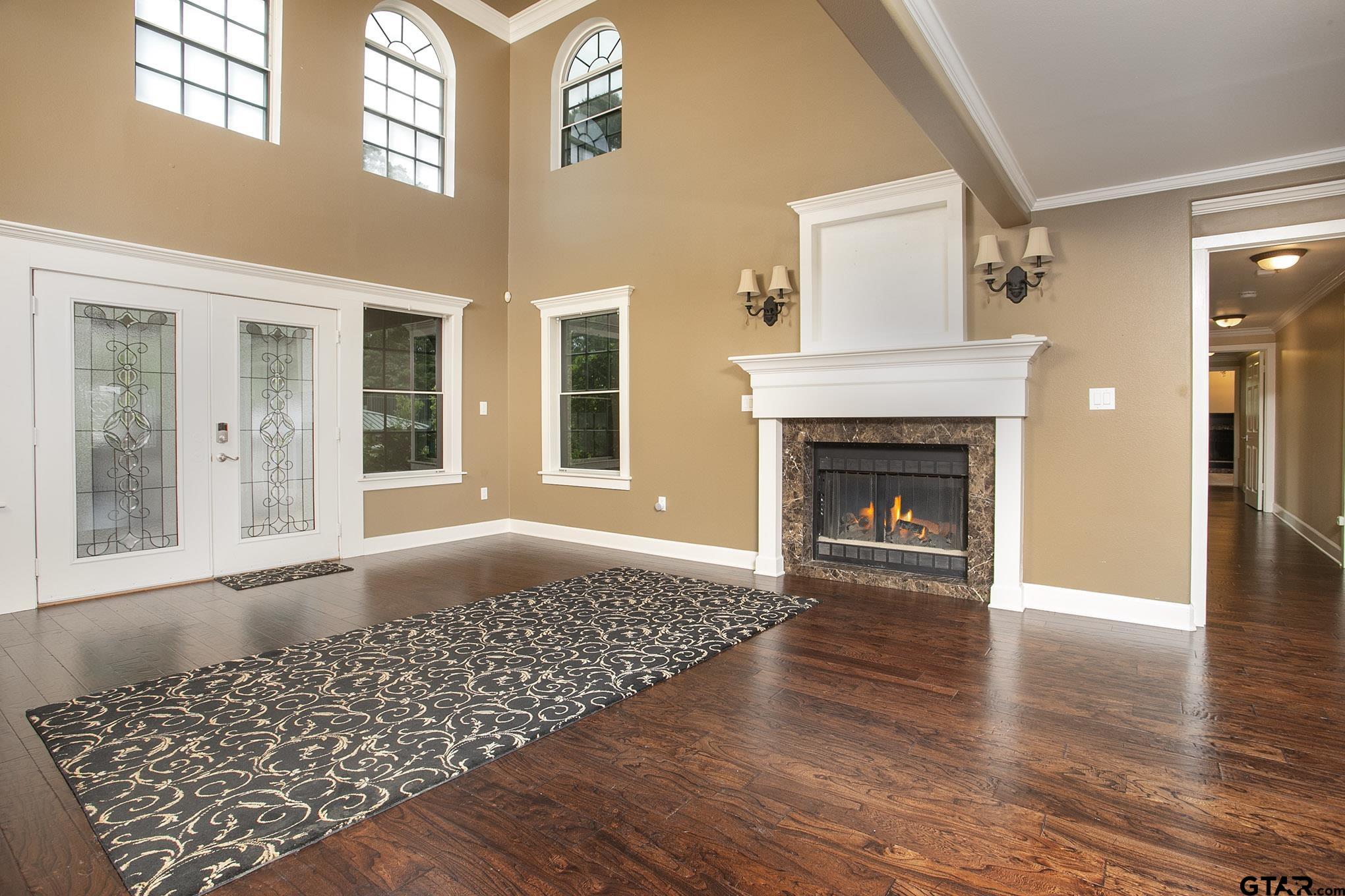 18722 Ridgeline Road Tyler, TX 75703 - Photo 17 of 47 Living Room with beautiful wood floors and wood burning fireplace.