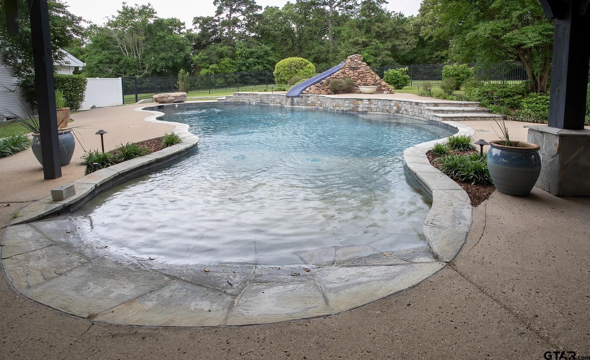 18722 Ridgeline Road Tyler, TX 75703 - Photo 23 of 47 Custom Pool with Beach Entry, Diving Rock, and Tiled Slide.
