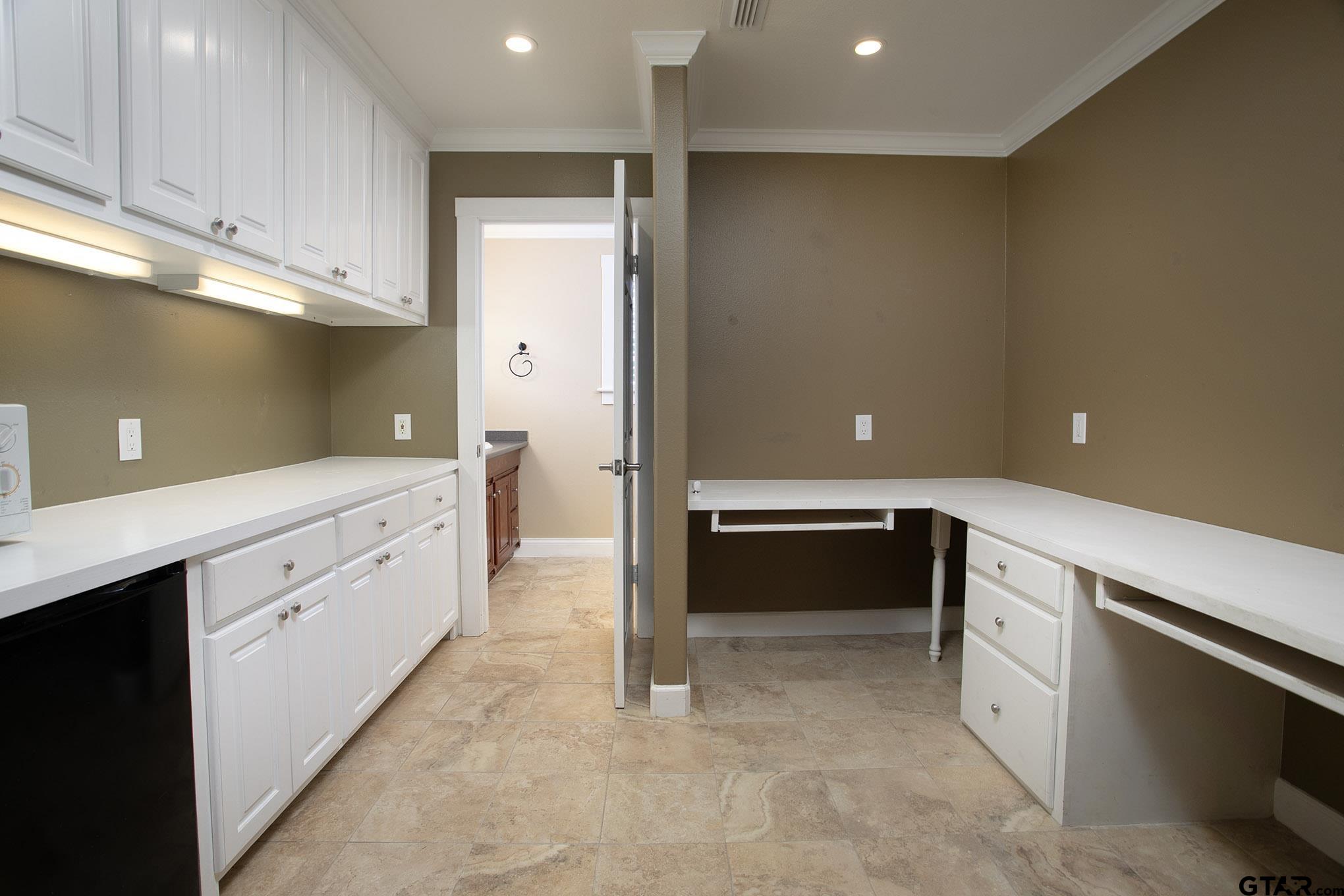 18722 Ridgeline Road Tyler, TX 75703 - Photo 38 of 47 a large white kitchen with a sink a stove and a refrigerator