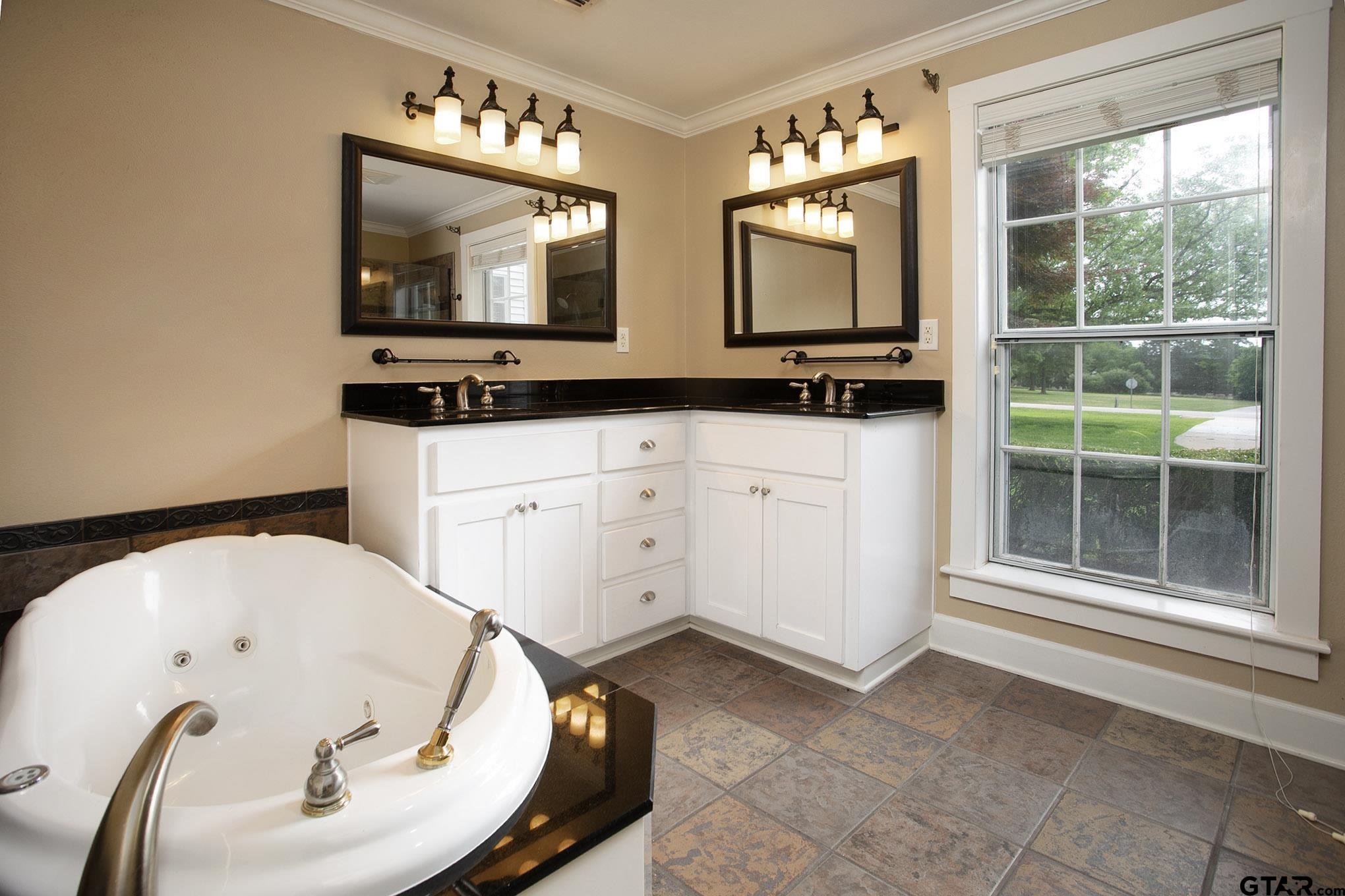 18722 Ridgeline Road Tyler, TX 75703 - Photo 8 of 47 a bathroom with a tub sink and mirror