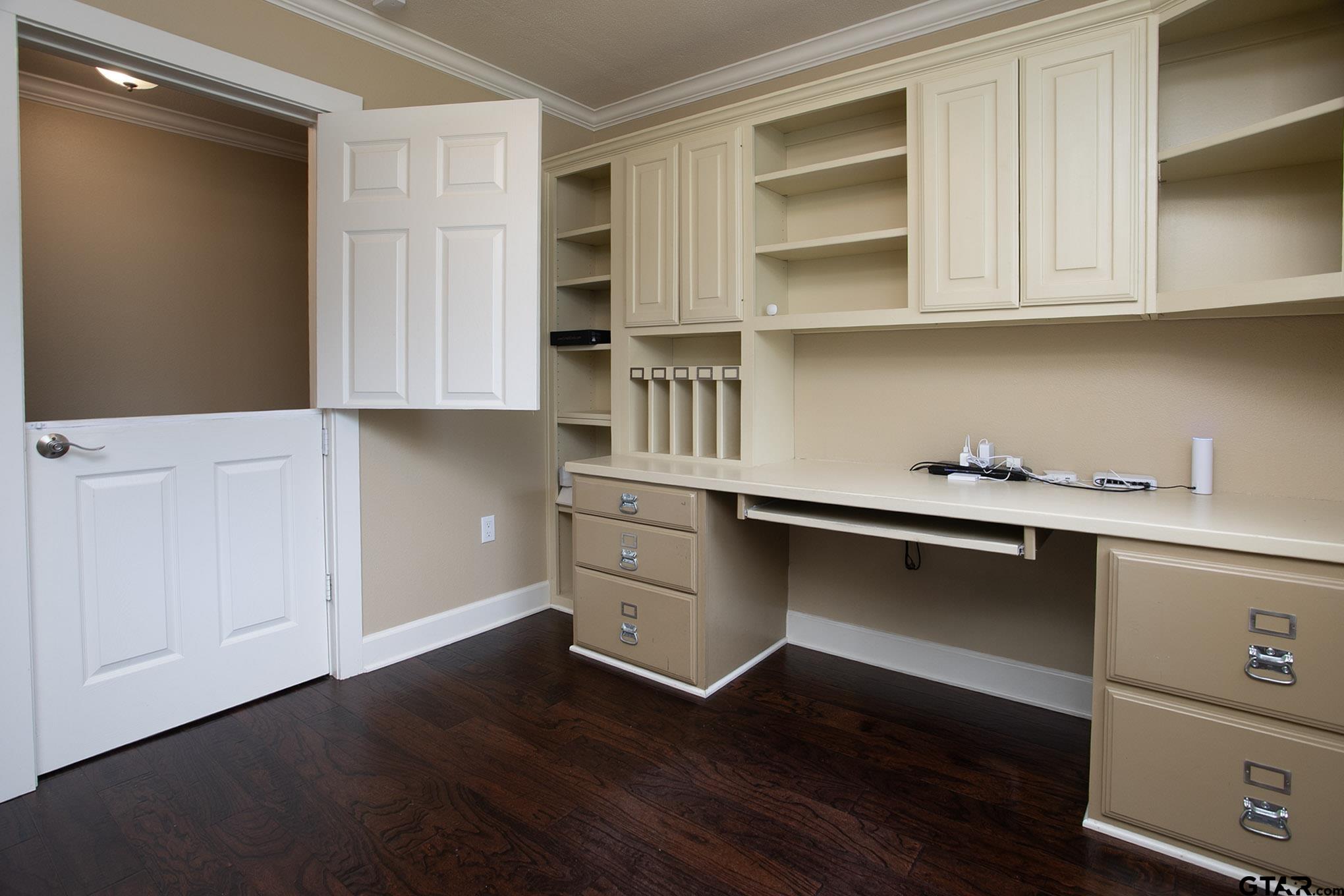 18722 Ridgeline Road Tyler, TX 75703 - Photo 10 of 47 Office located in the Master Wing of the home, Built-in Desk and shelving and custom split door.