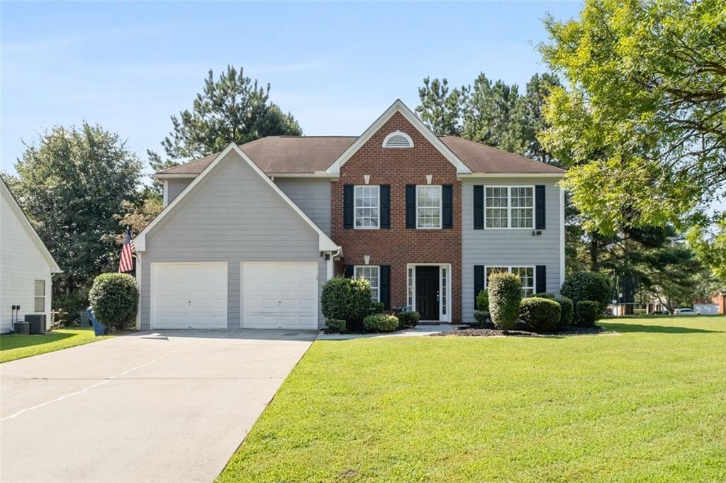 a front view of a house with a yard